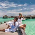 Couple in white on a tropical beach at Maldives