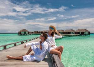 Couple in white on a tropical beach at Maldives