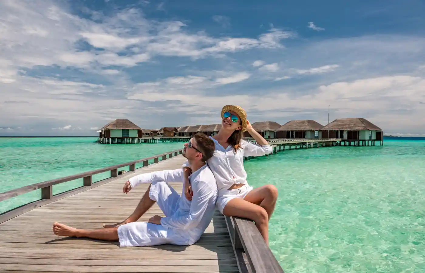 Couple in white on a tropical beach at Maldives