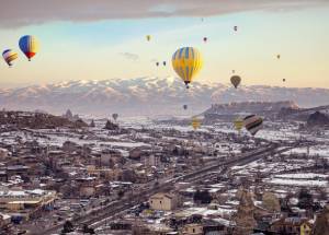 Hot Air Balloons Flying over City in Turkey.