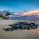 Rocks on a sea shore near a resort in Mauritius.