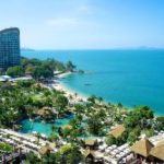 View of buildings and beach under clear sky in Pattaya.