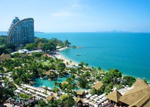 View of buildings and beach under clear sky in Pattaya.