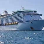 A white color cruise ship in water.