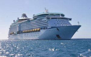 A white color cruise ship in water.