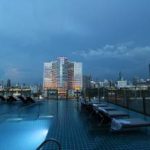 Pool side view of a building in Bangkok city.