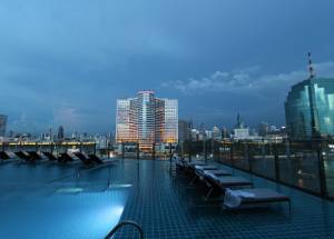 Pool side view of a building in Bangkok city.