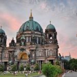 people walking infront of a cathedra in Berlin.