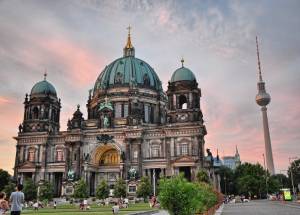 people walking infront of a cathedra in Berlin.