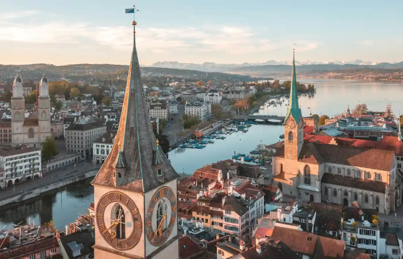 Brown and white concrete building near body of water during daytime in Zurich.