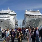 Cruise ship at port with people around.