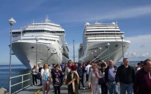 Cruise ship at port with people around.