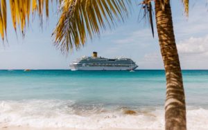 White cruise ship sailing in water body.