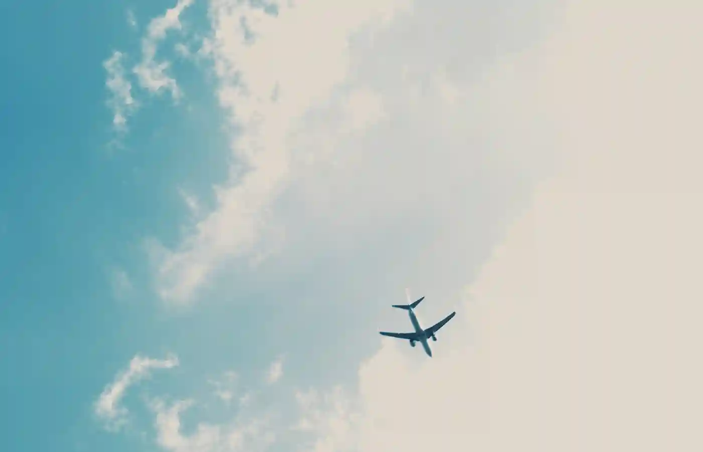 Passenger plane under blue sky.