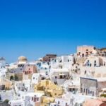 concrete houses under blue sky in Thera, Greece.