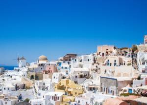 concrete houses under blue sky in Thera, Greece.