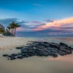 Rocks on seashore near a resort