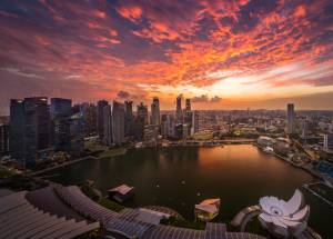 Photo of Singapore city under orange sky.