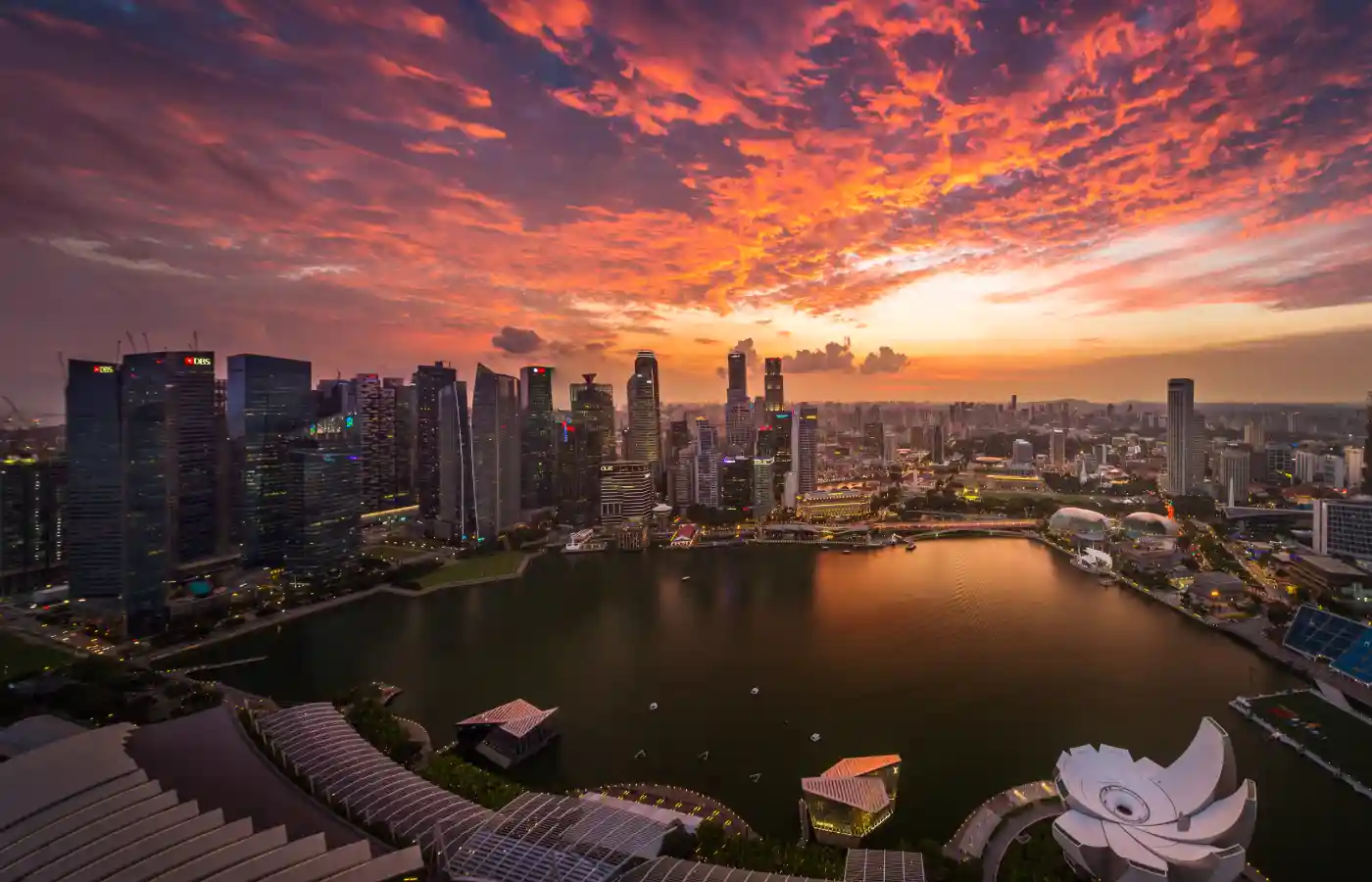 Photo of Singapore city under orange sky.