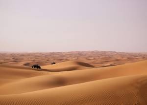 Brown sand in vast desert during the day time in Dubai.