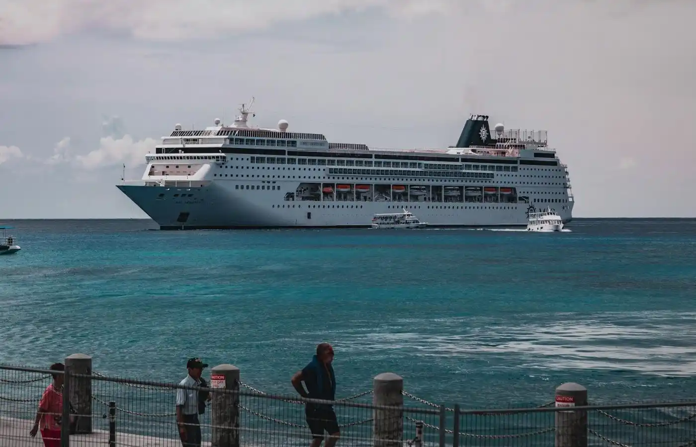 A white color cruise ship at a port.