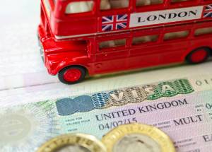 Uk visa and a double decker red color bus image.