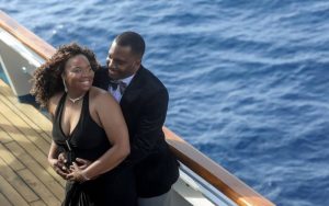 A man and woman holding each other in black attire .