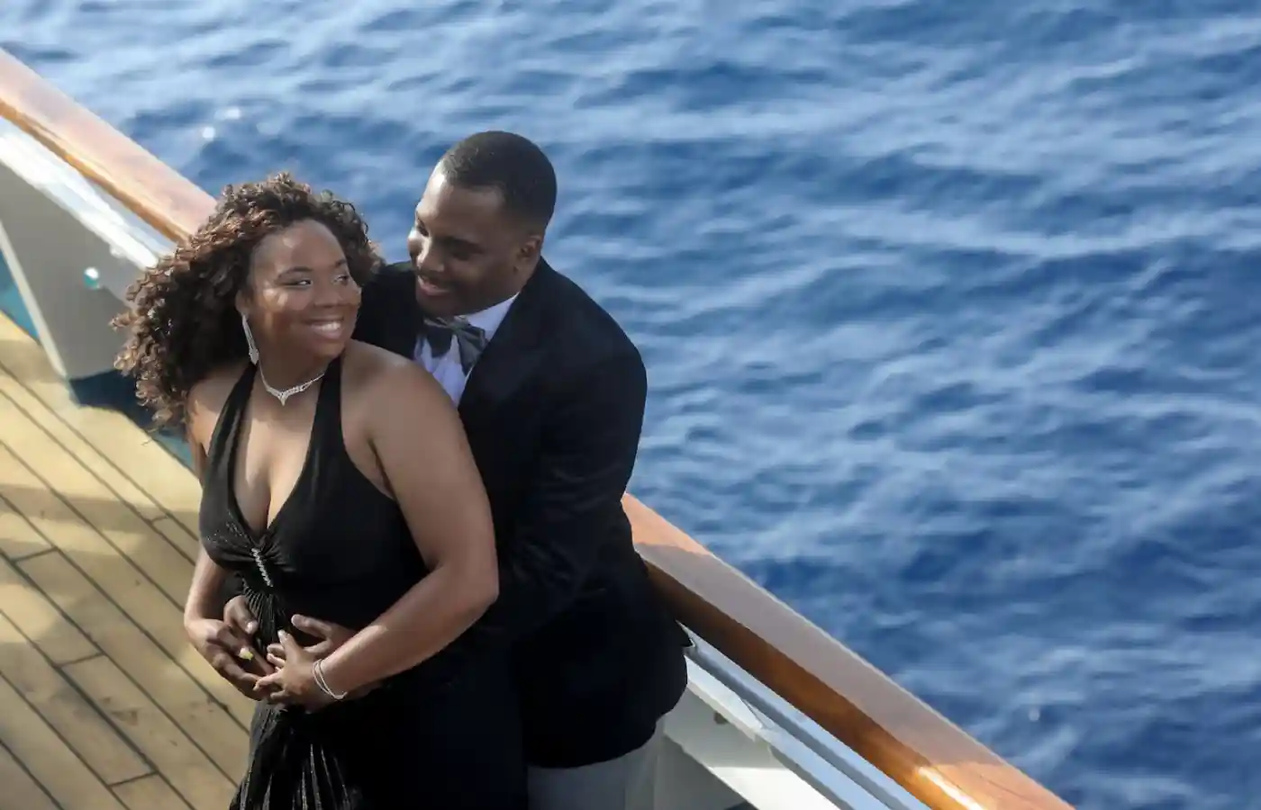 A man and woman holding each other in black attire .