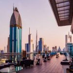 skyscrapers of downtown Dubai from a rooftop coffee bar at sunset