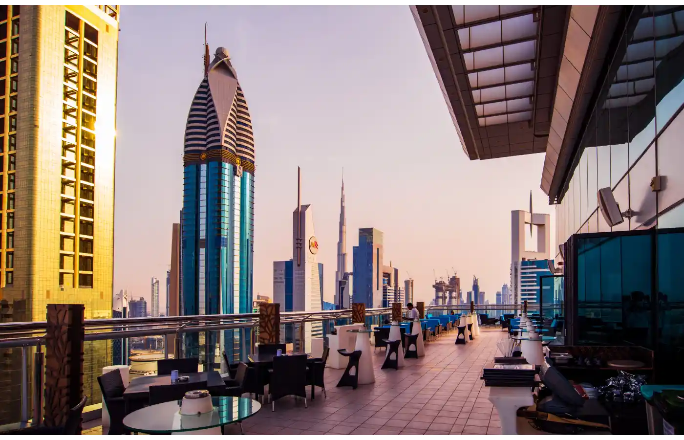 skyscrapers of downtown Dubai from a rooftop coffee bar at sunset