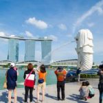 Tourist taking pictures at Merlion in Singapore.