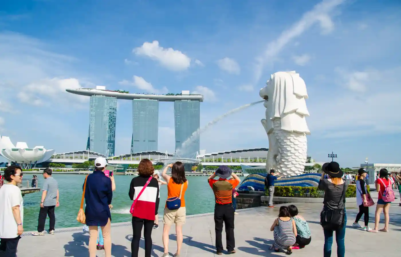 Tourist taking pictures at Merlion in Singapore.