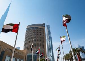 UAE flags waving besides Dubai Mall