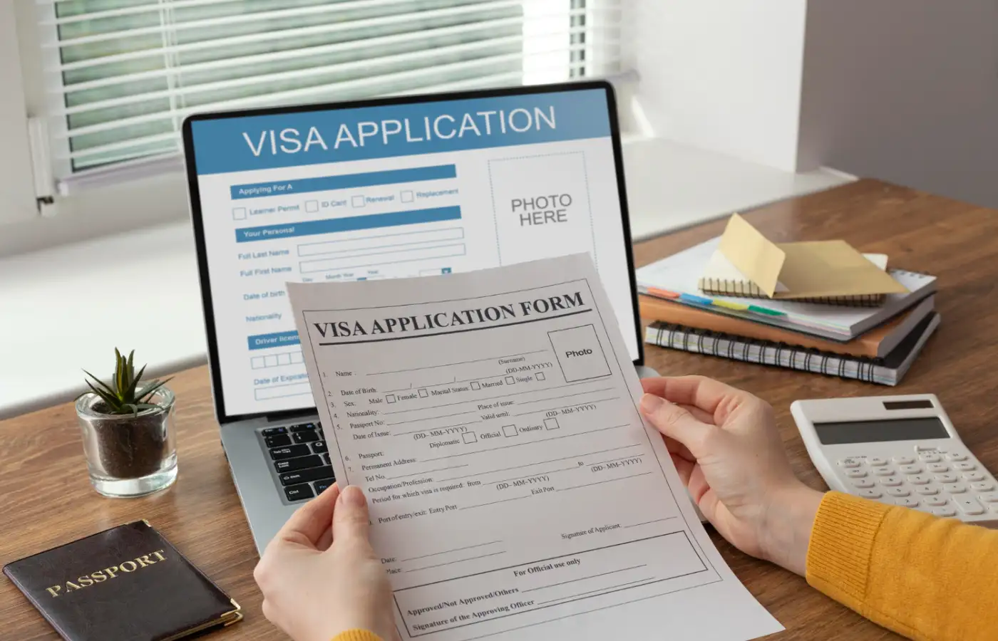 Visa application form and a laptop screen.