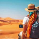 A woman with a hat watching desert.