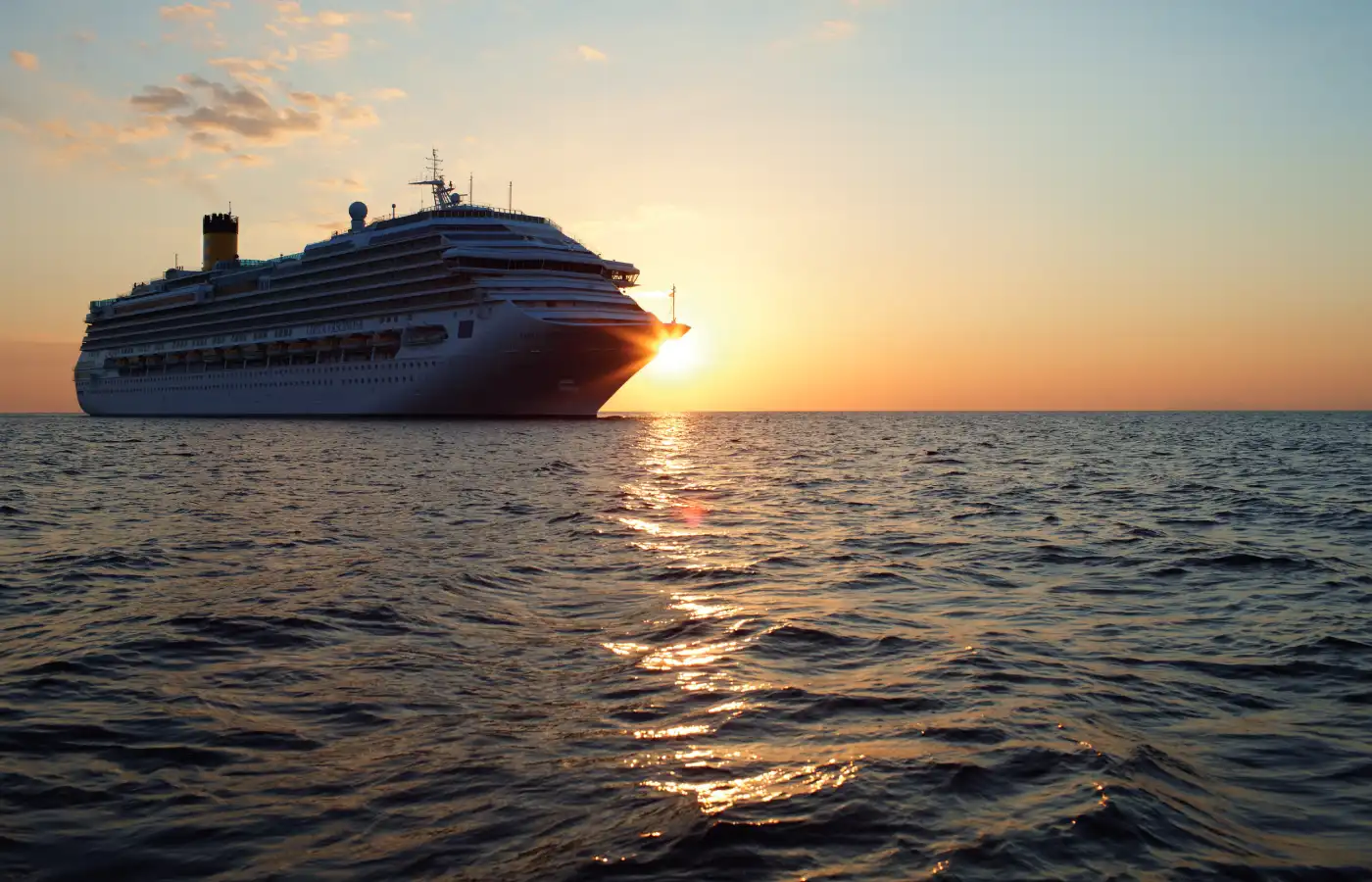 A cruise ship sailing in the water body.