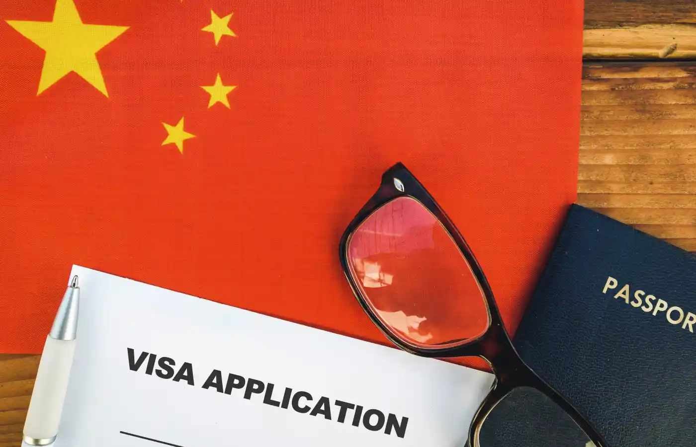 Flag of China , visa application form and passport on table