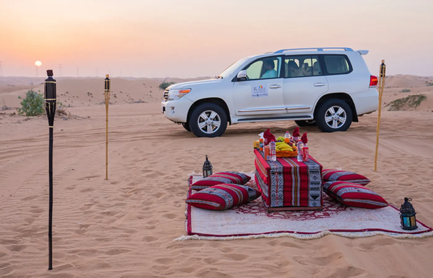 A white car in desert under the sky.