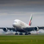 Plane landing with emirates written on it