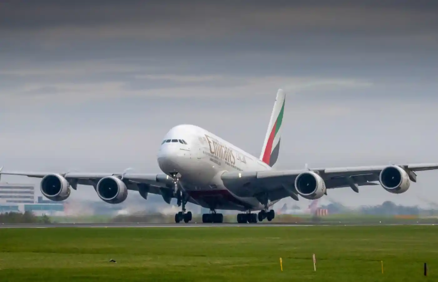 Plane landing with emirates written on it