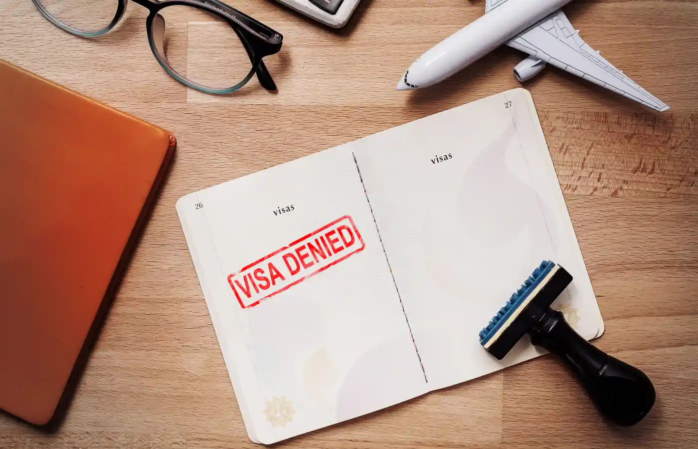 visa and passport with denied stamp on a document top view in immigration.