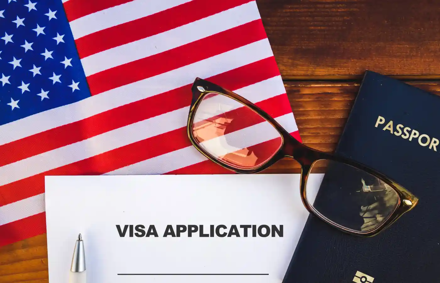 Flag of United State , visa application form and passport on table