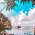 Beautiful girl on swing Nusa Penida island Bali.