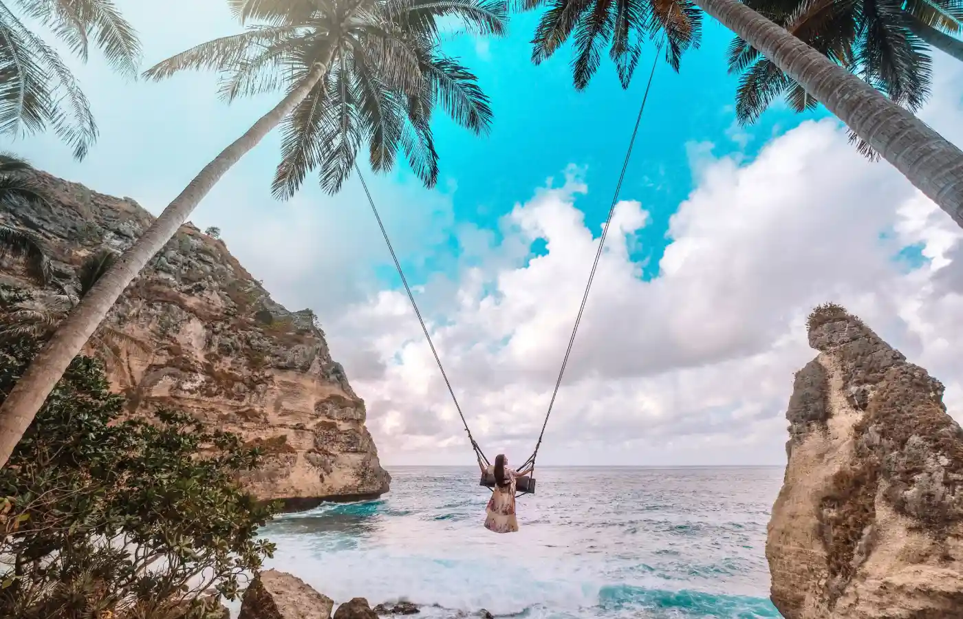 Beautiful girl on swing Nusa Penida island Bali.