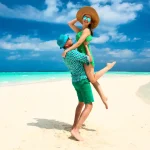 Couple in green on a tropical beach at Maldives