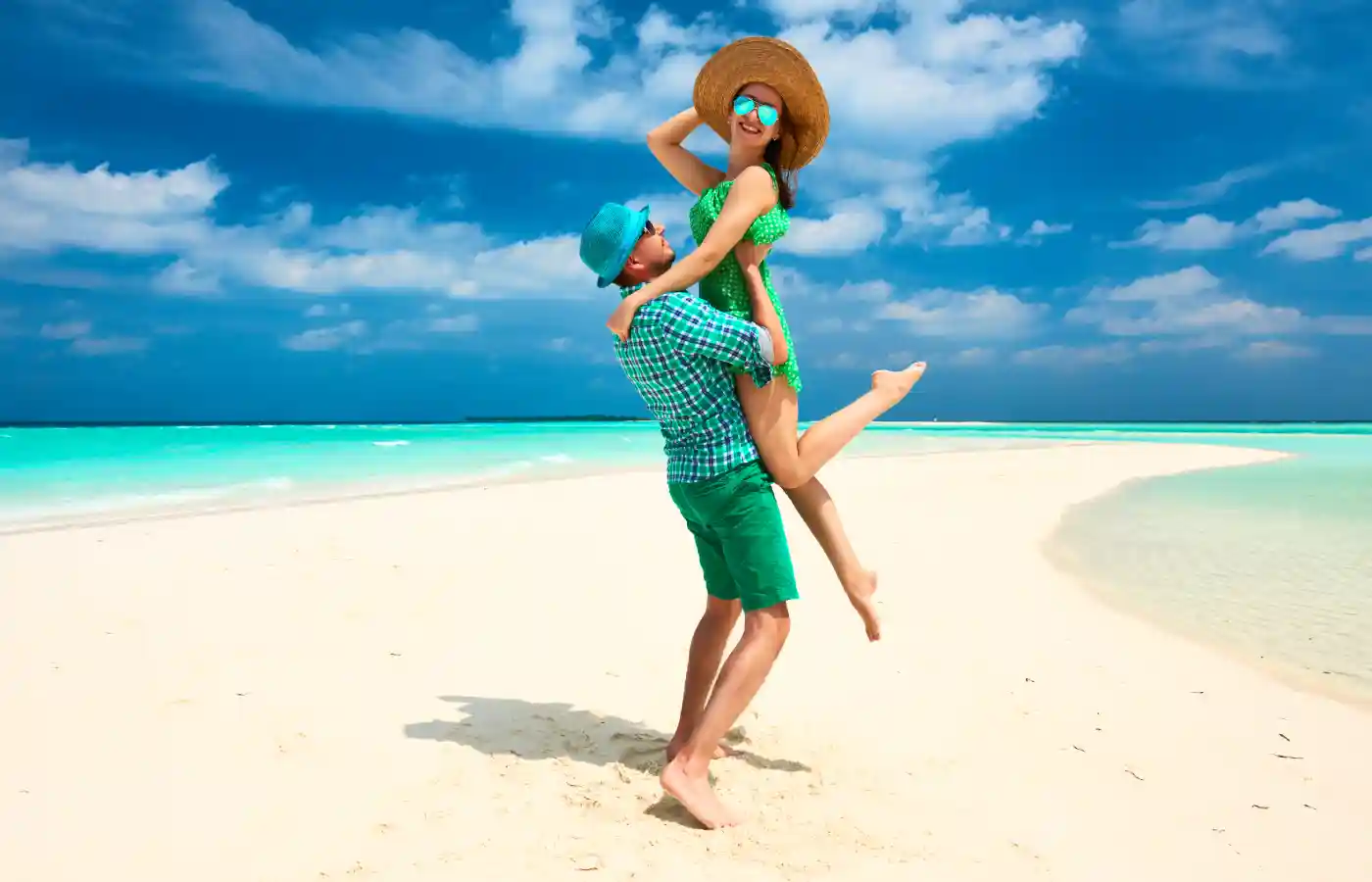 Couple in green on a tropical beach at Maldives