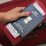 Tourist holding Indian Passport.