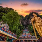 Statue of Lord Muragan and entrance at sunset in Batu Caves, Kuala Lumpur, Malaysia.