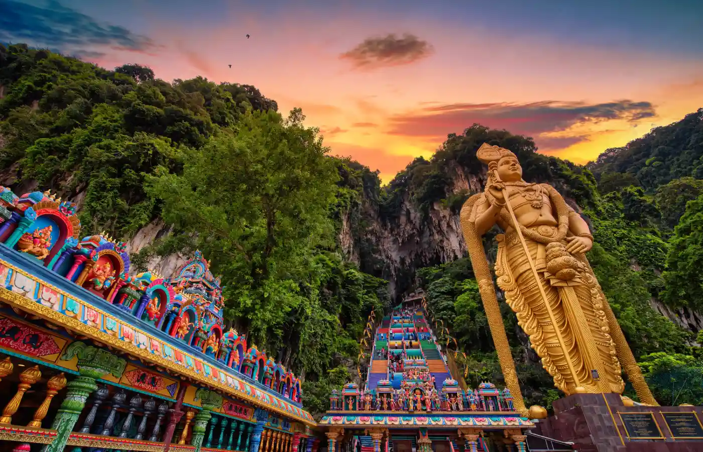 Statue of Lord Muragan and entrance at sunset in Batu Caves, Kuala Lumpur, Malaysia.