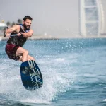 Wakeboarder enjoying a perfect day in Dubai Marina with Burj Al Arab in the background